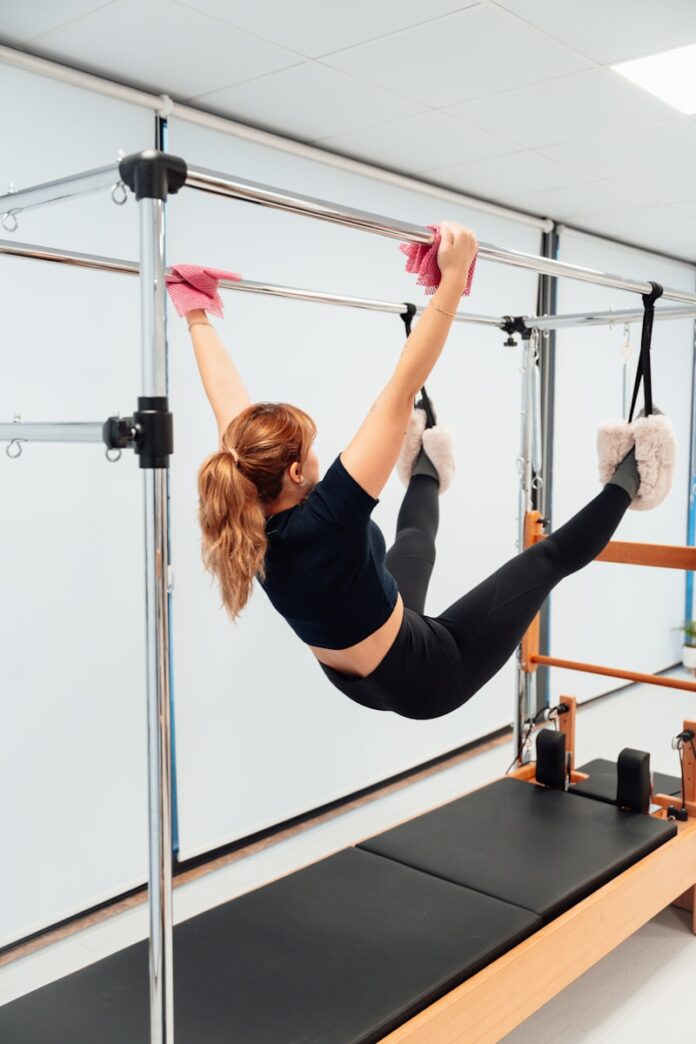 a woman in a black shirt doing aerial acrobatics
